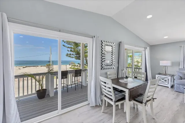 an aerial view of a residential houses with outdoor space and ocean view