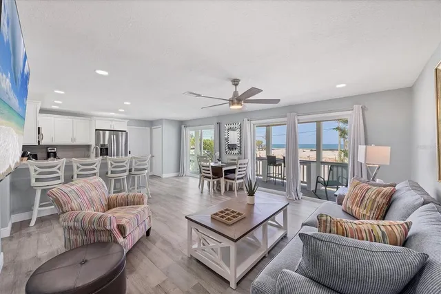 a kitchen with granite countertop a sink and a refrigerator