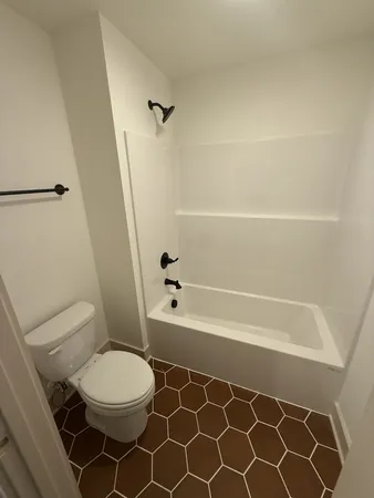 a bathroom with a toilet a sink and a shower