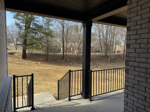 a view of a porch with a floor to ceiling window and wooden fence