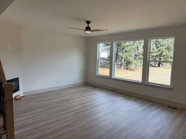 wooden floor in an empty room with a window