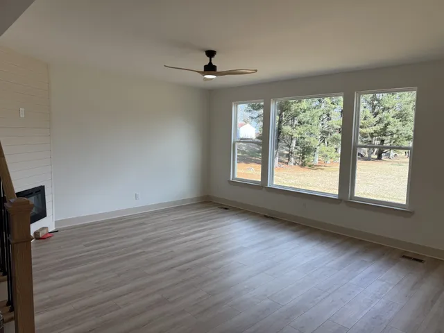 wooden floor in an empty room with a window