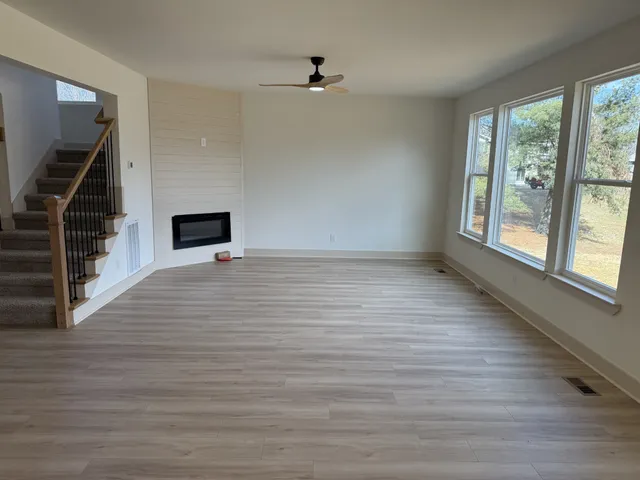 wooden floor in an empty room with a window