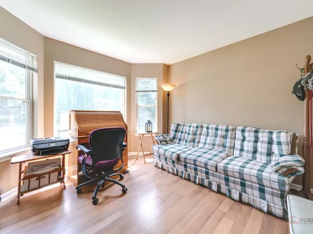 a living room with furniture fireplace and a floor to ceiling window