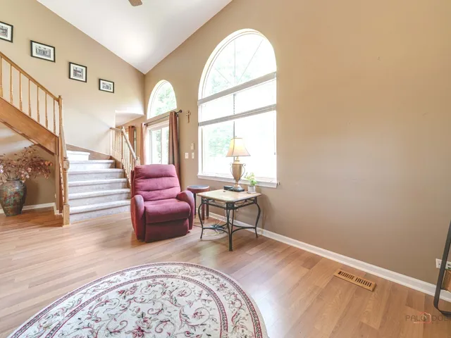 a living room with furniture a fireplace and a large window