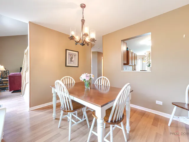 a view of a dining room with furniture wooden floor and a chandelier
