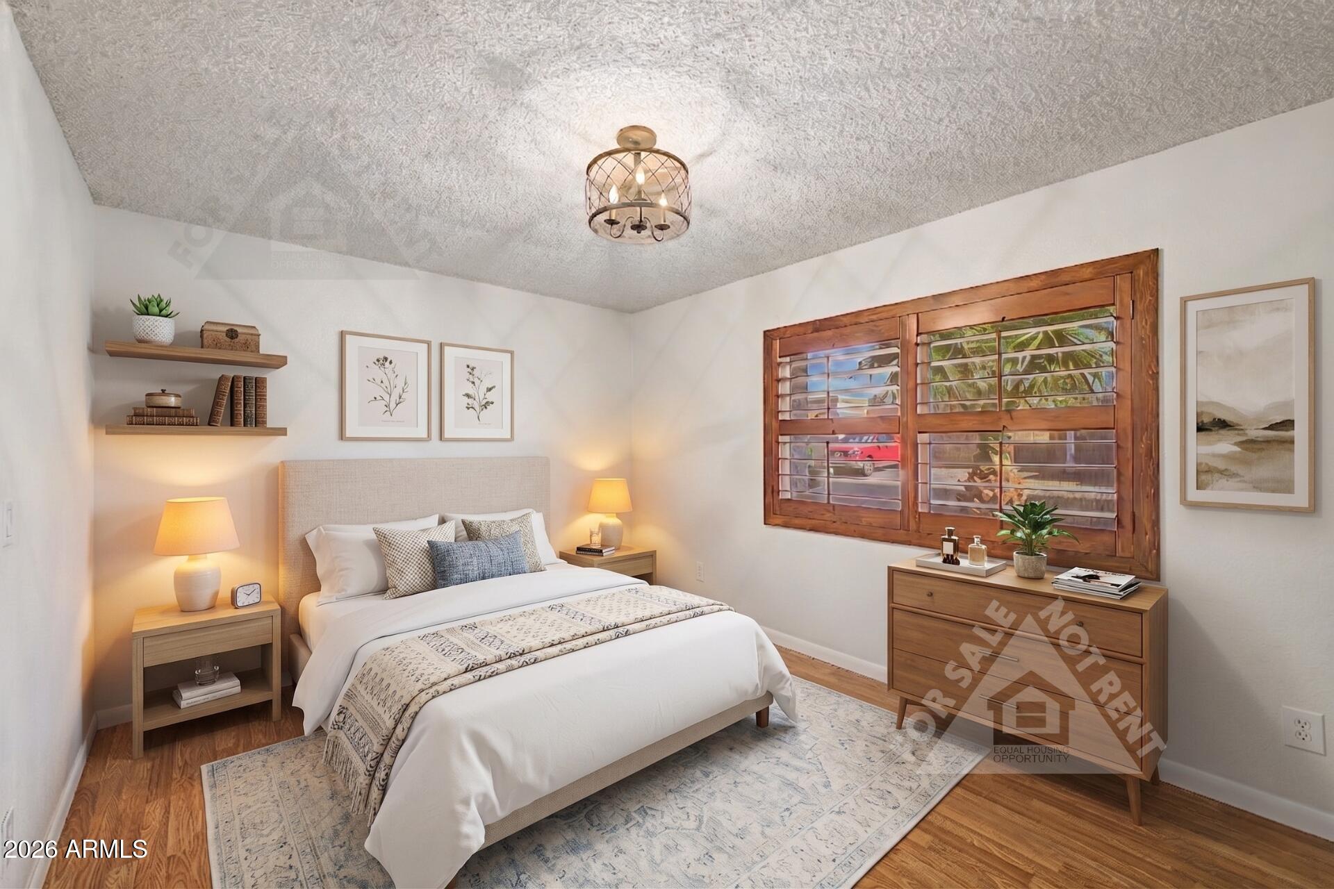 912 East Villa Rita Drive Phoenix, AZ 85022 - Photo 13 of 27 a bedroom with a bed and wooden floor