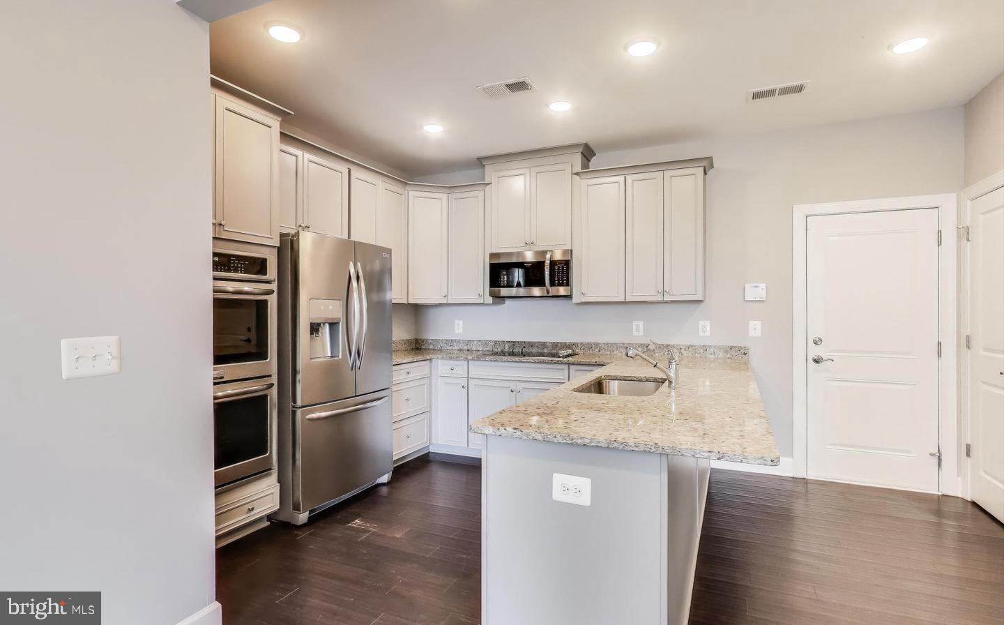10473 Ratcliffe Trail Manassas, VA 20110 - Photo 3 of 3 a kitchen with a refrigerator and a sink