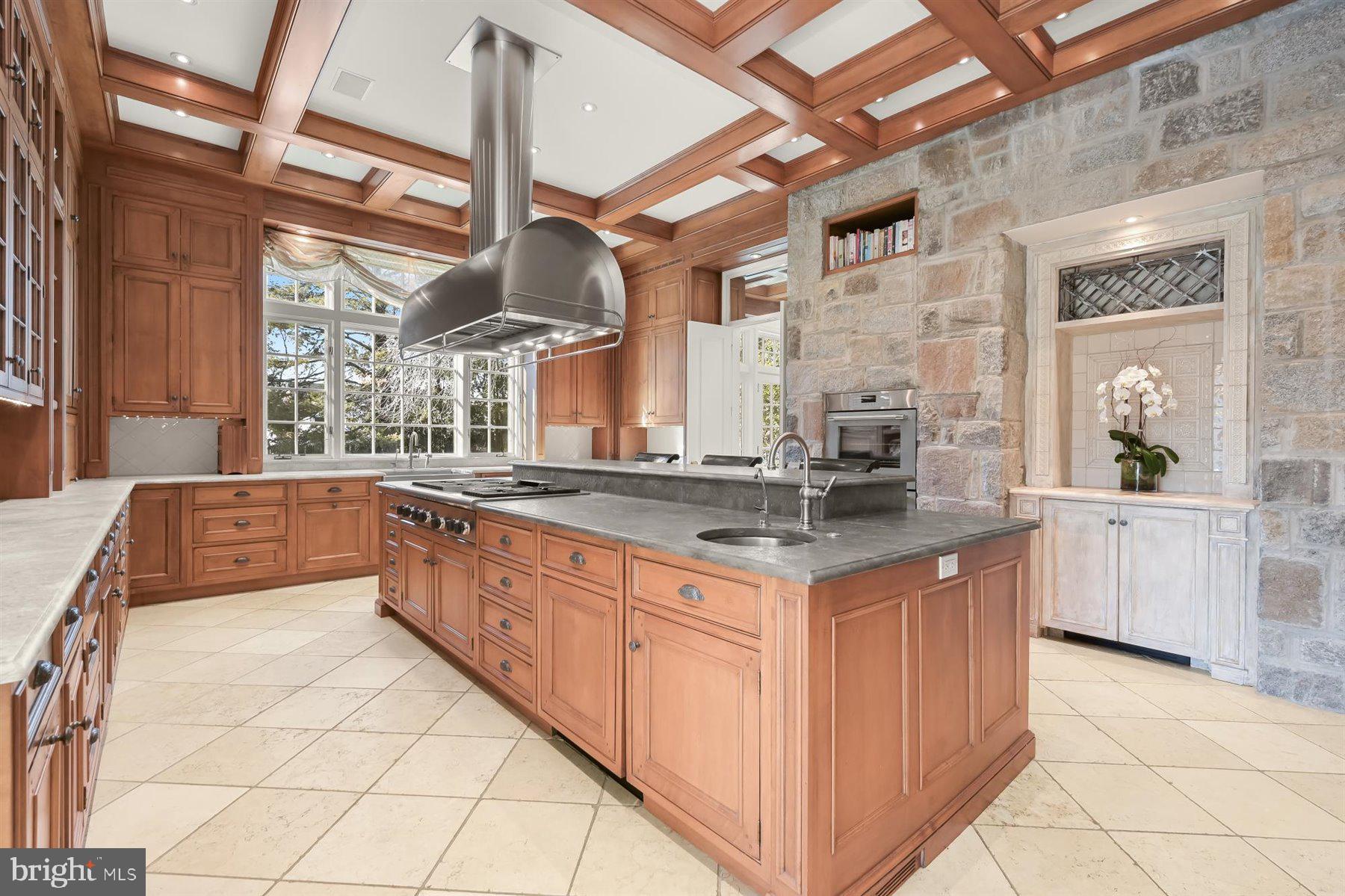 5320 27th Street Northwest Washington, DC 20015 - Photo 15 of 42 a large kitchen with granite countertop a sink and a stove