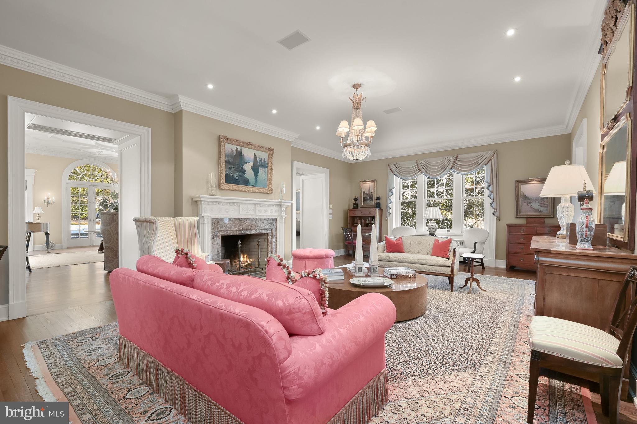 5320 27th Street Northwest Washington, DC 20015 - Photo 8 of 42 a living room with furniture a fireplace and a chandelier