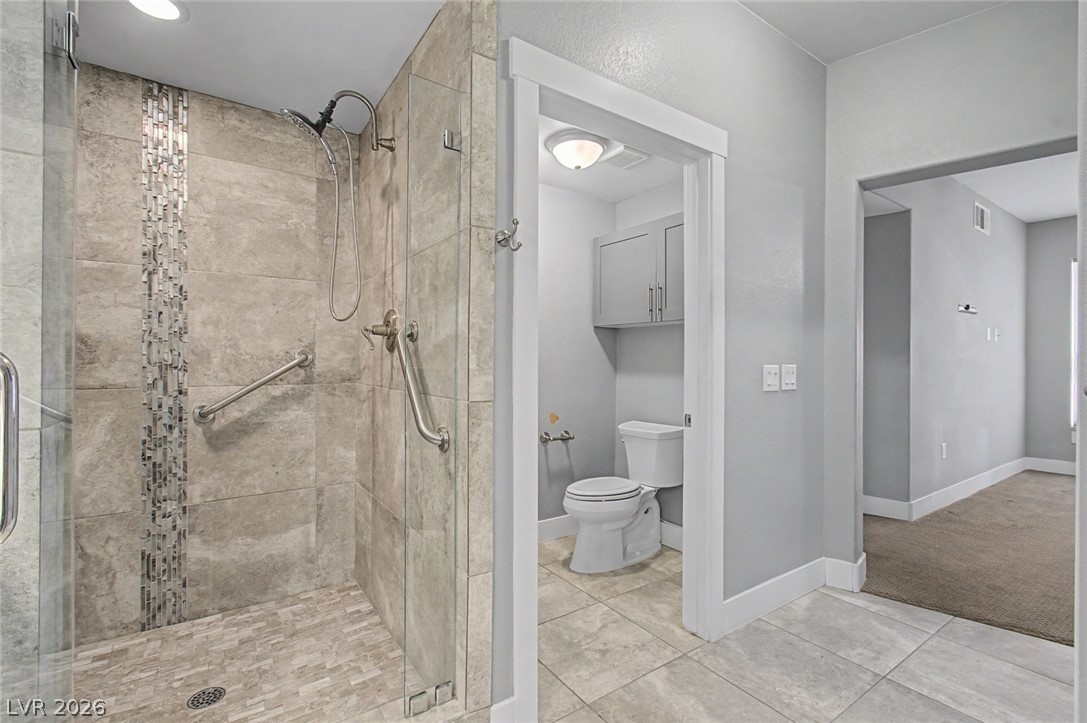 2555 Hampton Road, Unit 6308 Henderson, NV 89052 - Photo 19 of 30 Designer tile work walk-in shower features large glass access door & new toilet.