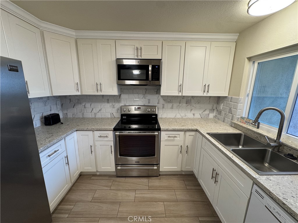 34102 Selva Road, Unit 364 Dana Point, CA 92629 - Photo 6 of 17 a kitchen with stainless steel appliances granite countertop a sink and a stove
