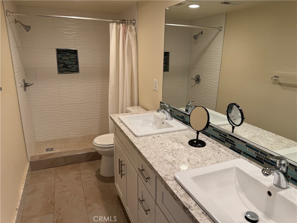 34102 Selva Road, Unit 364 Dana Point, CA 92629 - Photo 10 of 17 a bathroom with a granite countertop sink toilet and shower