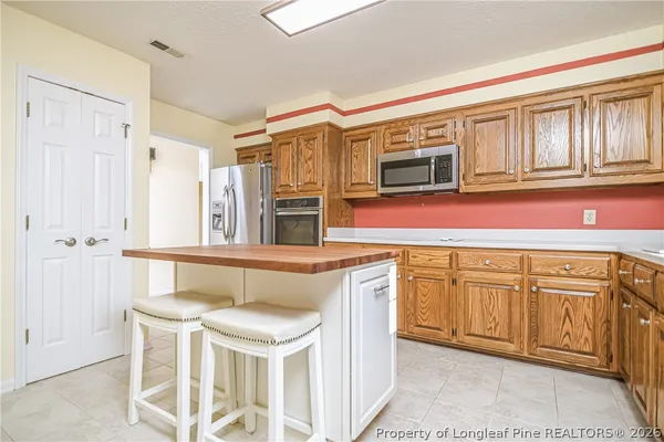 a kitchen with granite countertop a sink and cabinets