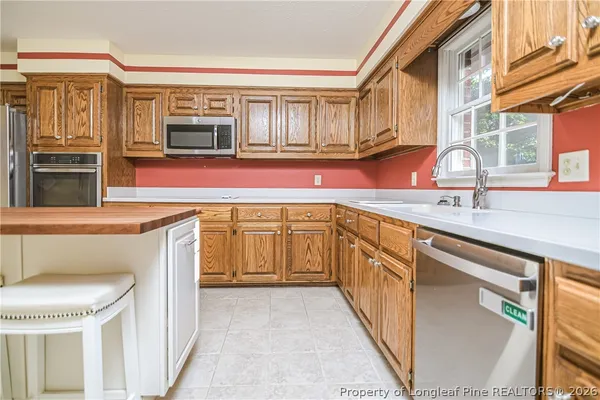 a kitchen with stainless steel appliances granite countertop a stove and more cabinets