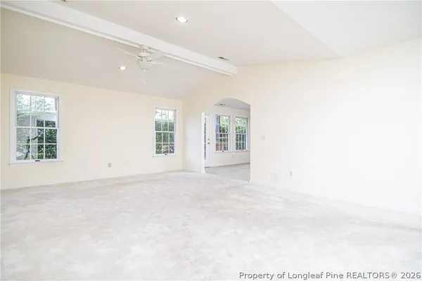 an empty room with windows and closet