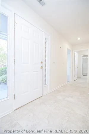 an empty room with a ceiling fan and a window