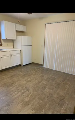a view of kitchen with white cabinets
