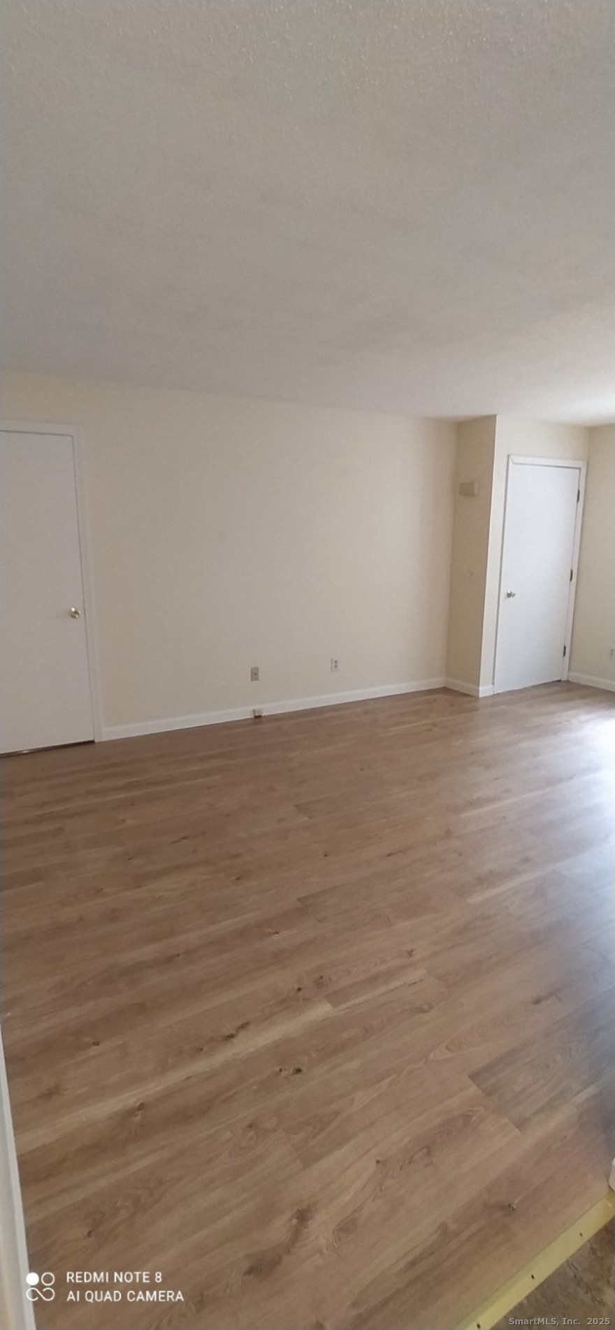 Undisclosed Address Gales Ferry, CT 06335 - Photo 5 of 8 a view of an empty room and wooden floor