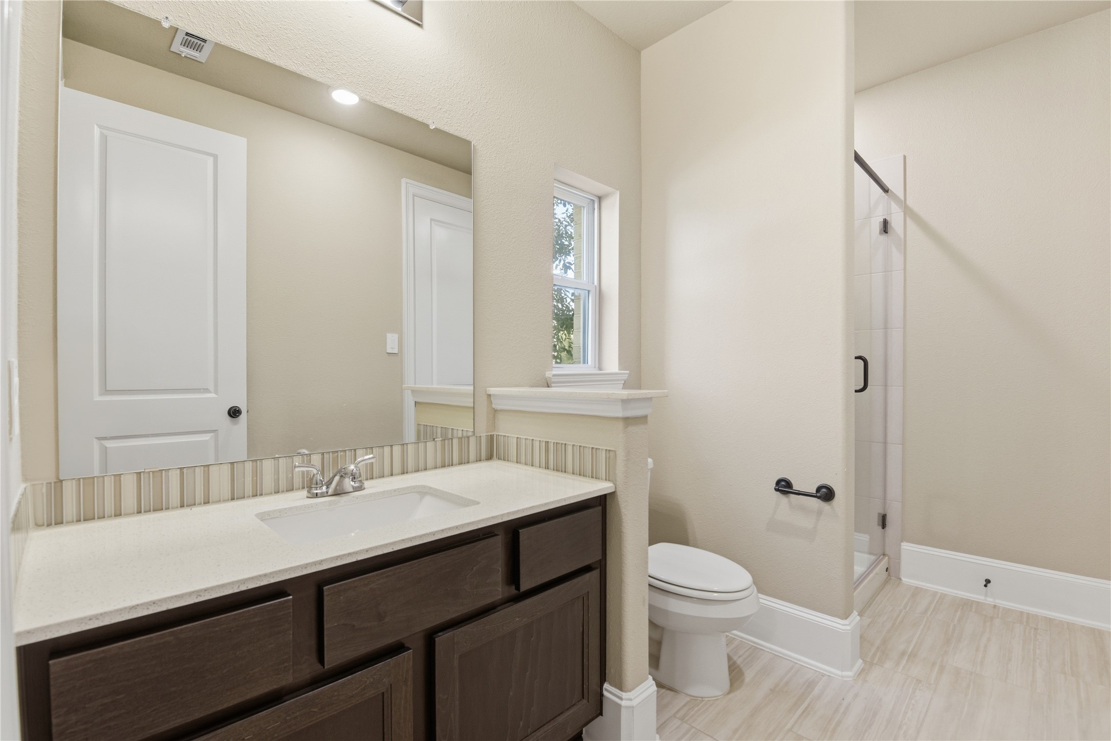 17501 Spice Merlot Lane Conroe, TX 77302 - Photo 35 of 50 a bathroom with a sink a toilet a shower and a mirror
