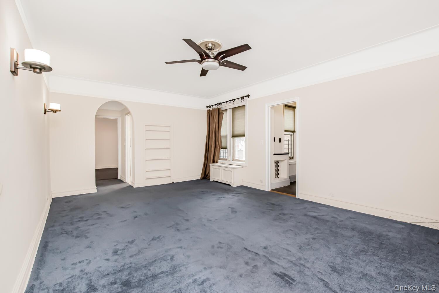 219 Bronx River Road, Unit 5A Yonkers, NY 10704 - Photo 7 of 14 a view of a livingroom with closet & a ceiling fan