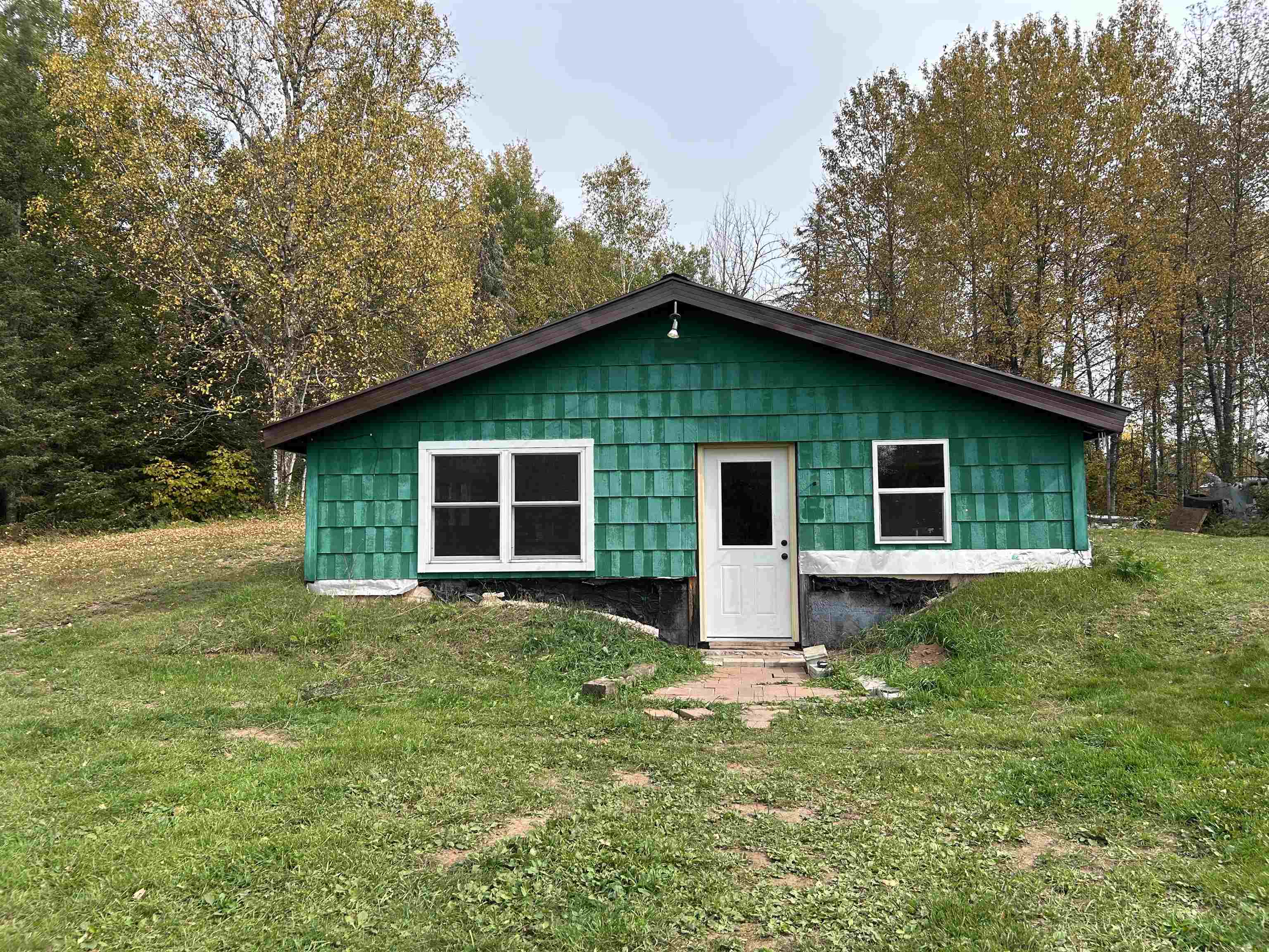 Rear view of property featuring a lawn