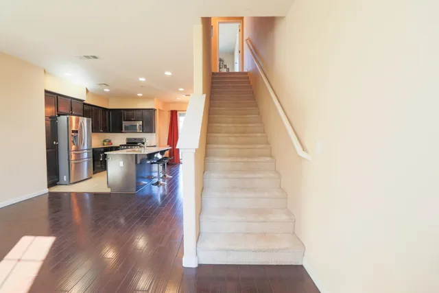 a view of a kitchen with wooden floor and electronic appliances