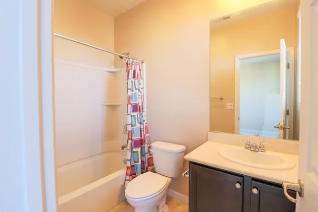 a bathroom with a sink toilet vanity and shower