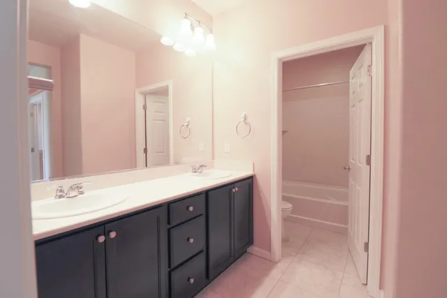 a bathroom with a double vanity sink mirror and double