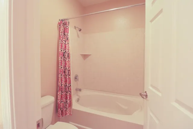 a bathroom with a bathtub and shower