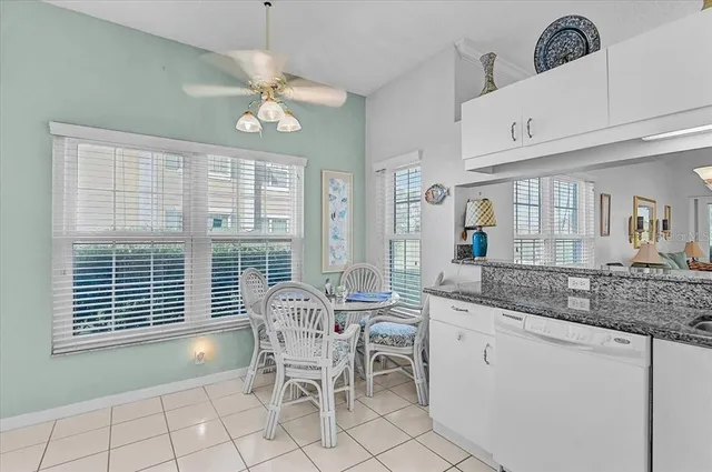 a living room with furniture and large windows