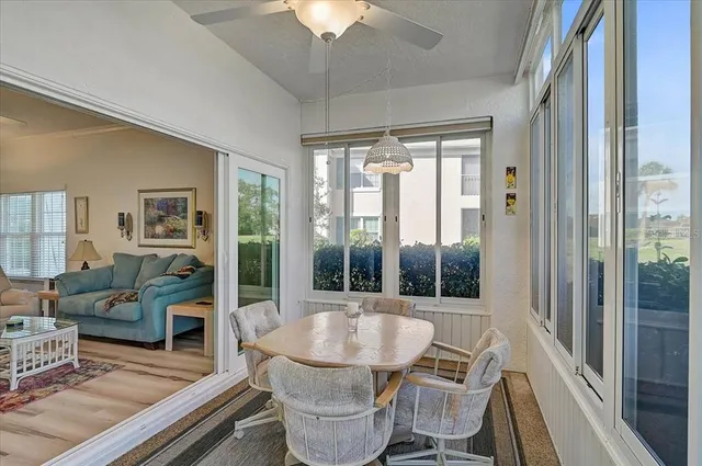 a view of a city from a dining room with large windows and wooden floor