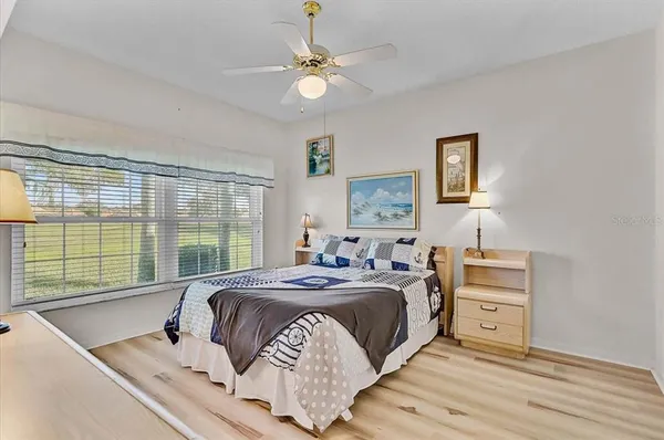 a bed sitting in a bedroom next to a window