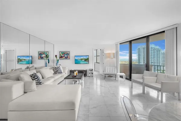 a living room with furniture and large windows