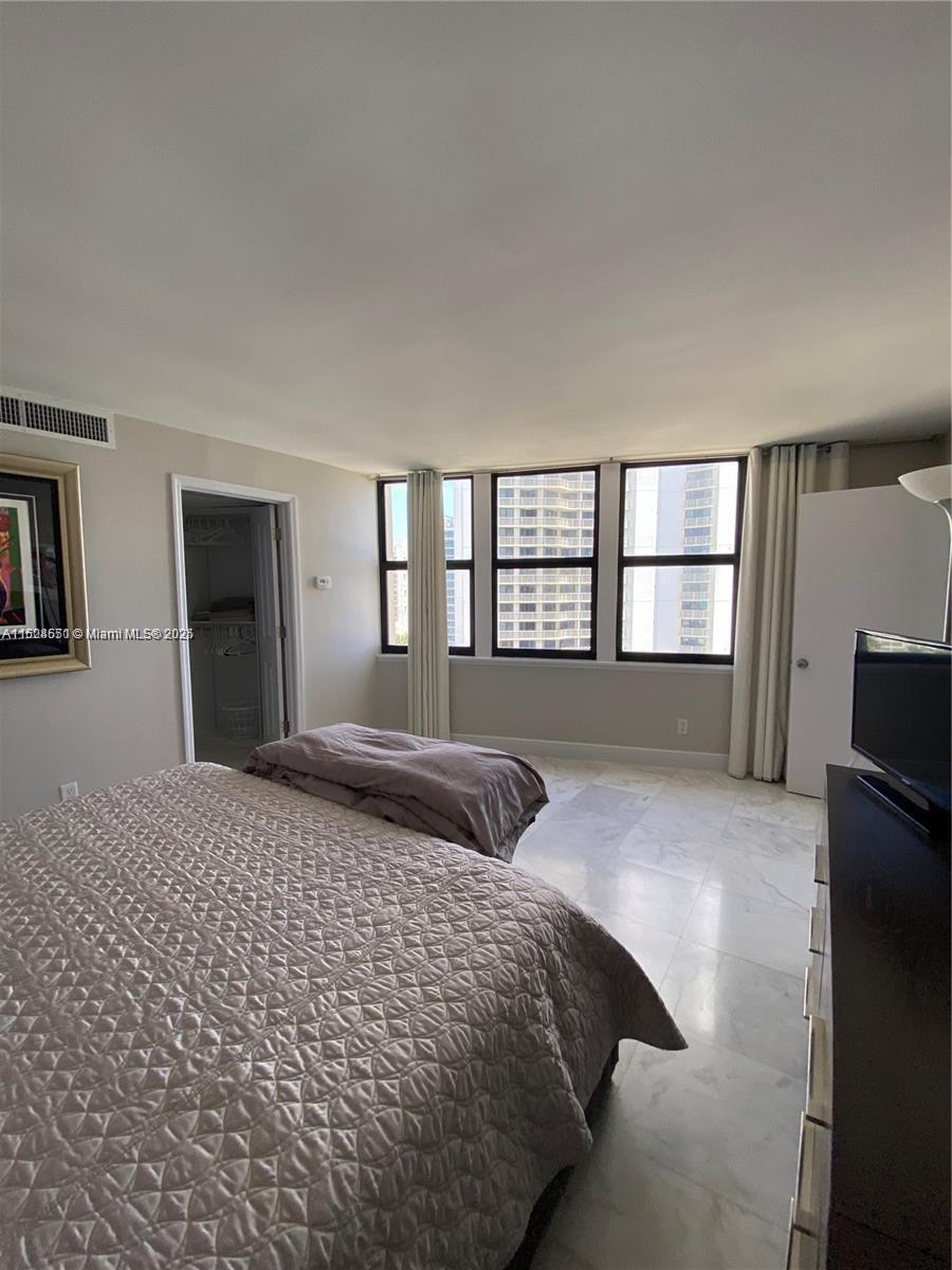 2800 North Ocean Drive, Unit B15C Riviera Beach, FL 33404 - Photo 11 of 32 a bedroom with a large bed and a window