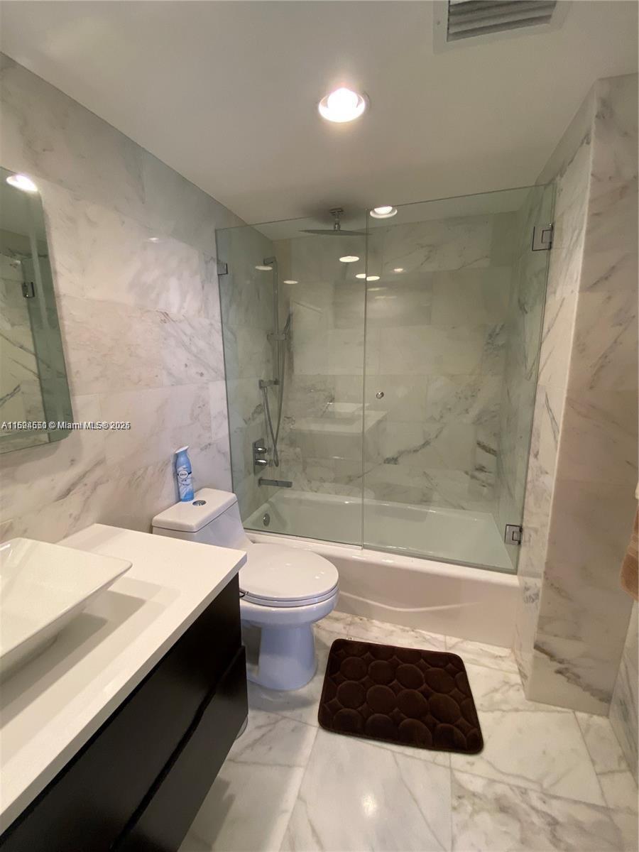 2800 North Ocean Drive, Unit B15C Riviera Beach, FL 33404 - Photo 13 of 32 a bathroom with a sink a toilet tub and shower