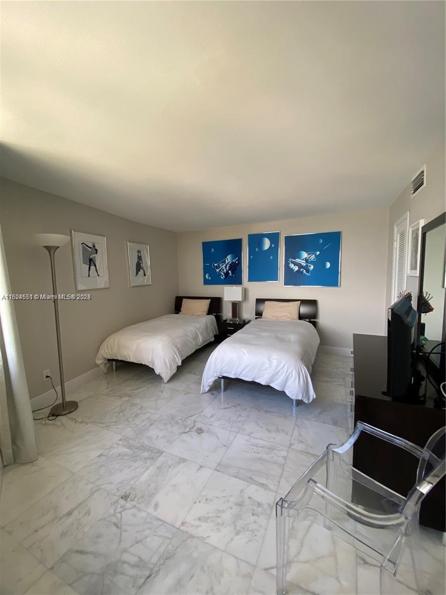 2800 North Ocean Drive, Unit B15C Riviera Beach, FL 33404 - Photo 15 of 32 a spacious bedroom with a bed and a couch