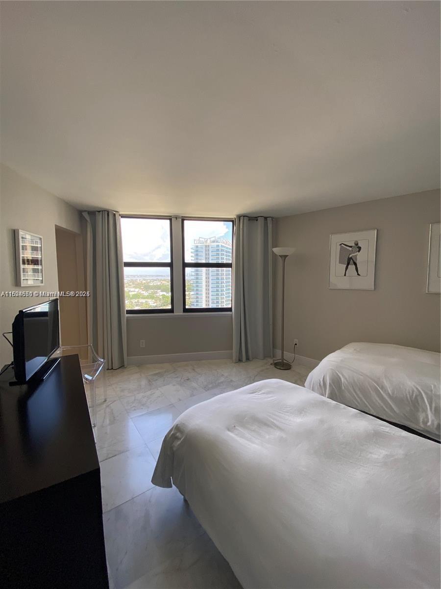 2800 North Ocean Drive, Unit B15C Riviera Beach, FL 33404 - Photo 16 of 32 a bedroom with a bed and a window