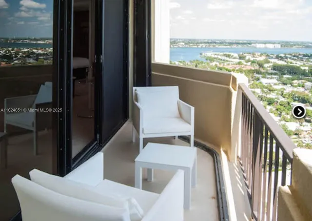 a view of a balcony with furniture