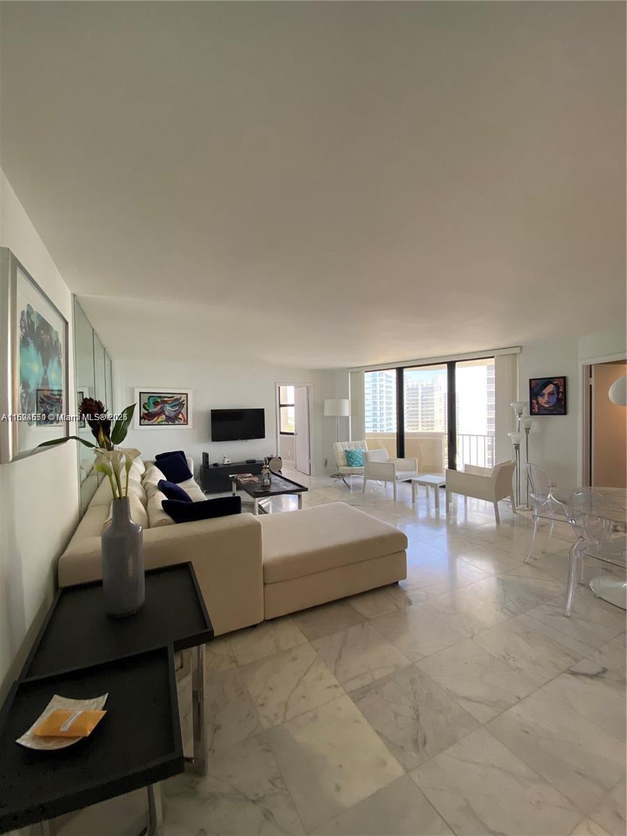 2800 North Ocean Drive, Unit B15C Riviera Beach, FL 33404 - Photo 5 of 32 a living room with furniture and a flat screen tv