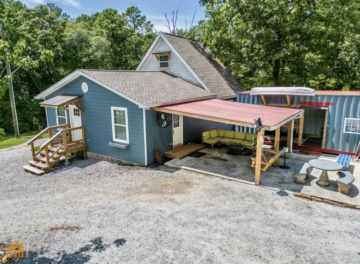 a view of a house with a patio and a yard