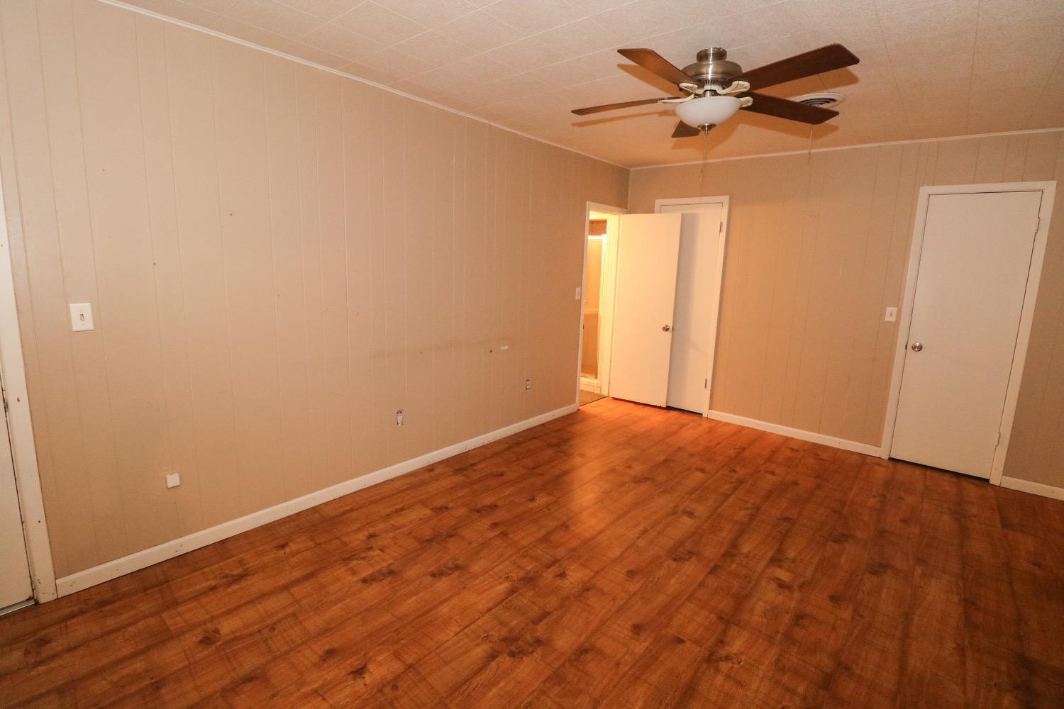 450 County Road 29 Muleshoe, TX 79347 - Photo 11 of 27 a view of empty room with wooden floor and fan