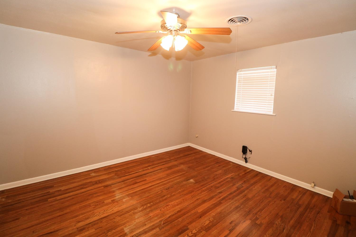 450 County Road 29 Muleshoe, TX 79347 - Photo 13 of 27 a view of a room with wooden floor and a ceiling fan