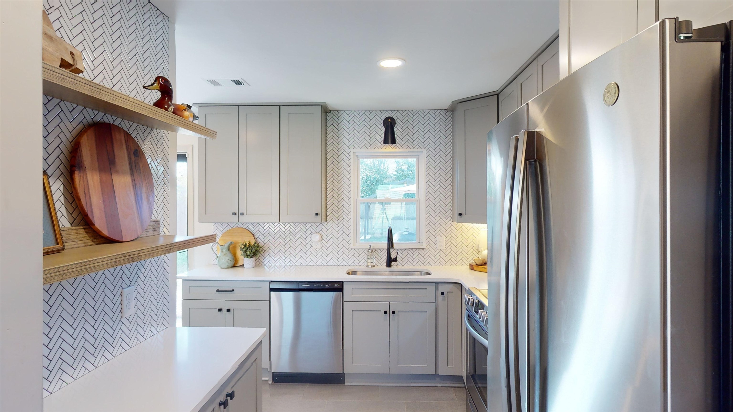4779 Dee Road Memphis, TN 38117 - Photo 12 of 35 a kitchen with refrigerator cabinets and a sink