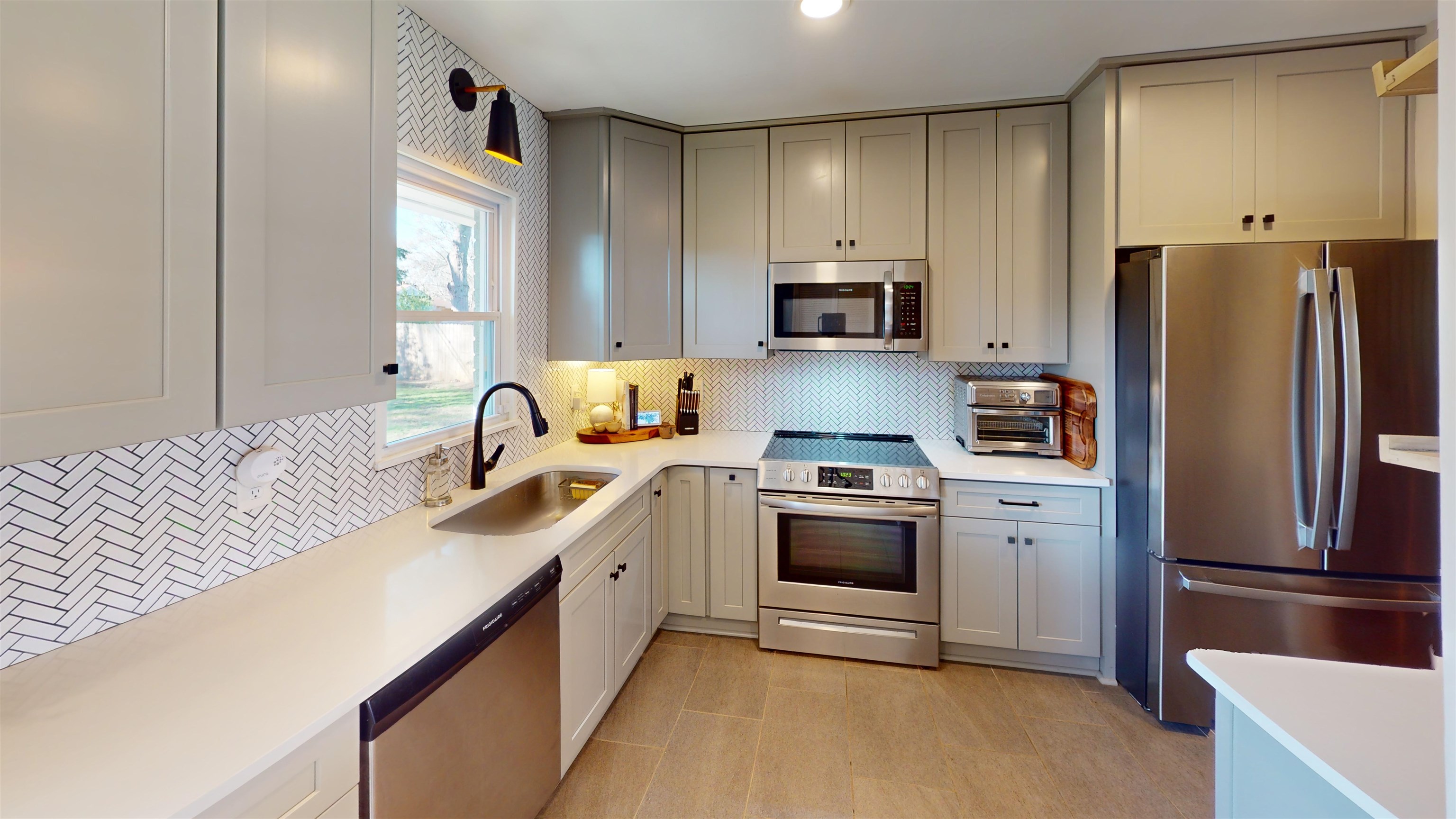 4779 Dee Road Memphis, TN 38117 - Photo 16 of 35 a kitchen with stainless steel appliances granite countertop a sink stove refrigerator and cabinets