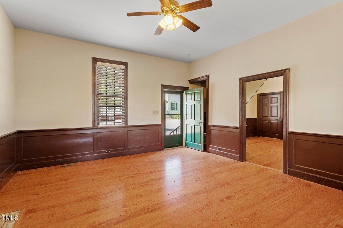 206 Shaver Road Macon, NC 27551 - Photo 48 of 68 a bedroom with a bed and a chandelier fan