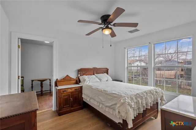 a bedroom with a bed and a chandelier