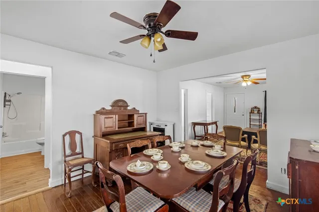a view of a dining room with furniture and wooden floor