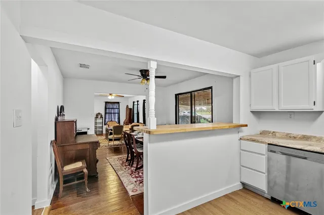 a view of a kitchen and dining room with wooden floor