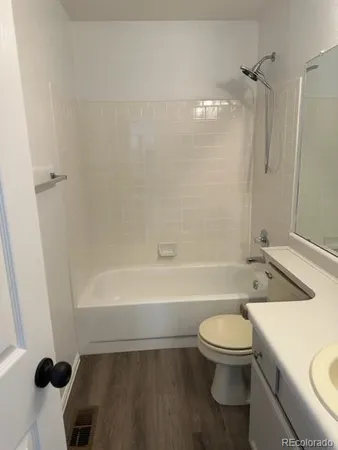a bathroom with a toilet a sink and bathtub